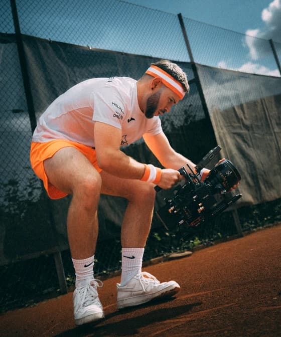 Kameramann von Dreamscope mit Gimbal-Rig beim Dreh auf einem Tennisplatz